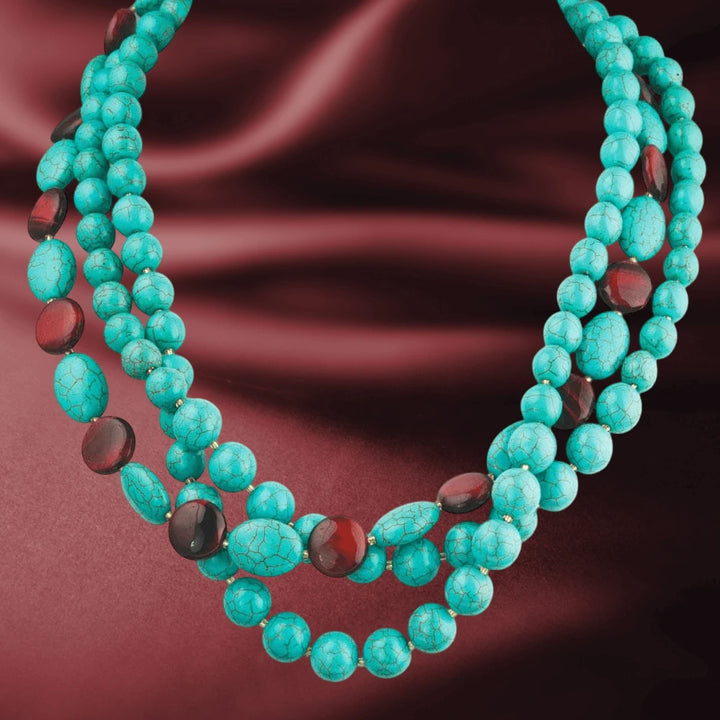 Turquoise and Tiger's Eye Necklace featuring sterling silver with gold plating, designed for women, showcasing vibrant turquoise and polished tiger's eye beads on a rich burgundy fabric background.
