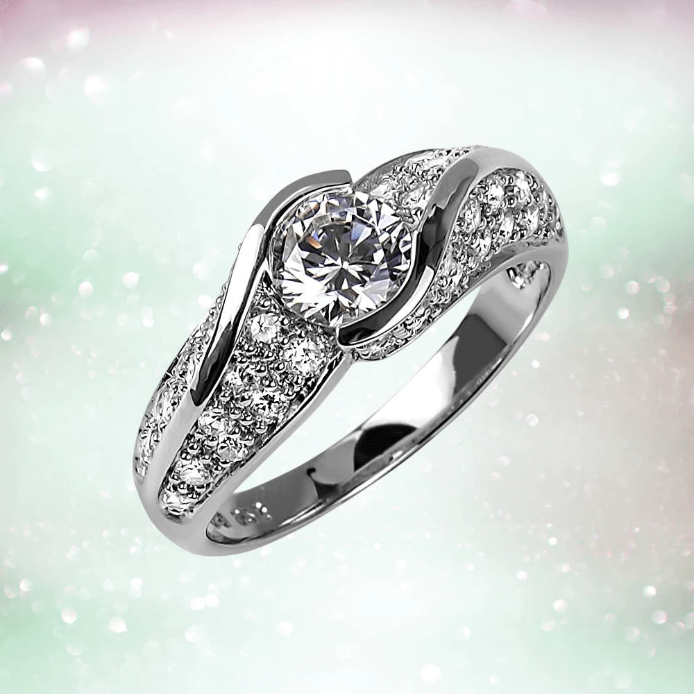 Sonata Ring in sterling silver for female, featuring a central round-cut gemstone surrounded by small sparkling stones on an elegant, polished band.