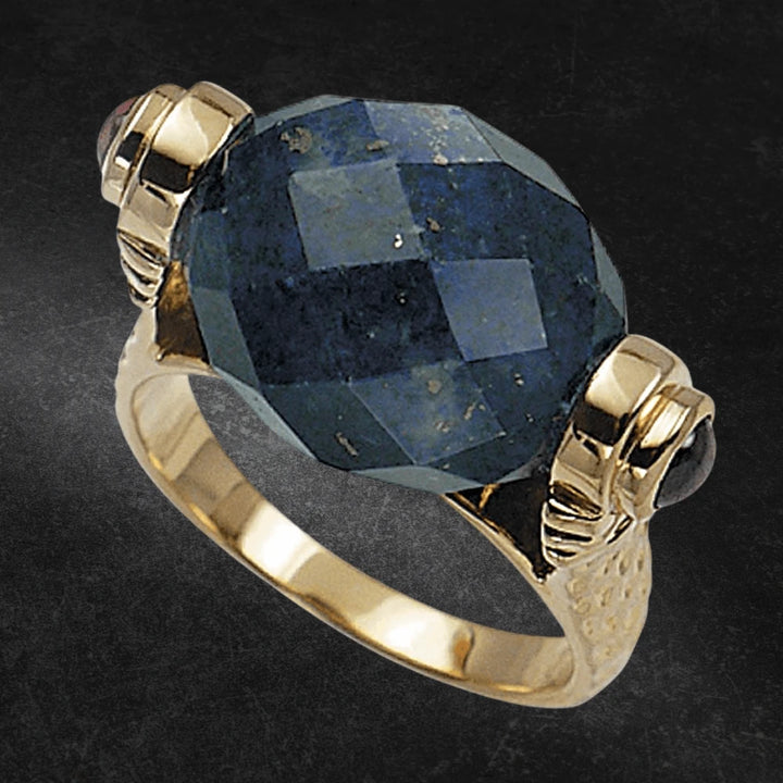 Lapis Lazuli Torque Ring featuring a large faceted lapis lazuli stone set in sterling silver with gold plating, designed for women’s elegant jewelry collections.