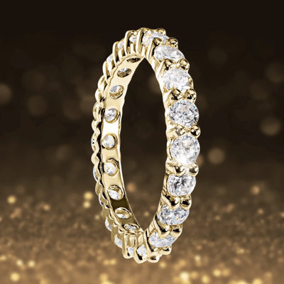 Gold Millionaire Tennis Eternity Ring in sterling silver with gold plating, featuring sparkling clear stones set in a continuous band designed for women’s jewelry.
