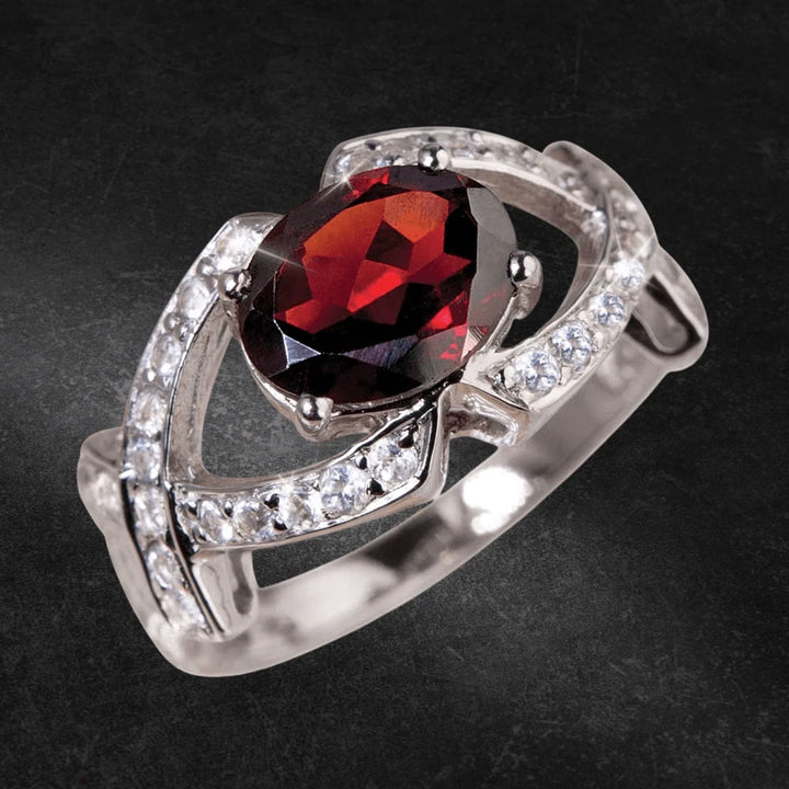 Rioja Garnet Ring featuring a deep red garnet center stone set in sterling silver with sparkling white accents, designed for women’s elegant jewelry collection.