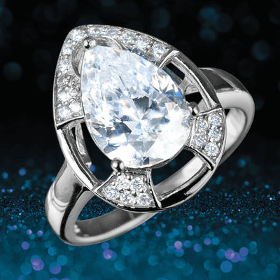 Mandalay Pear Ring featuring a large pear-shaped clear gemstone set in sterling silver with smaller sparkling stones accenting the elegant design for women’s jewelry.