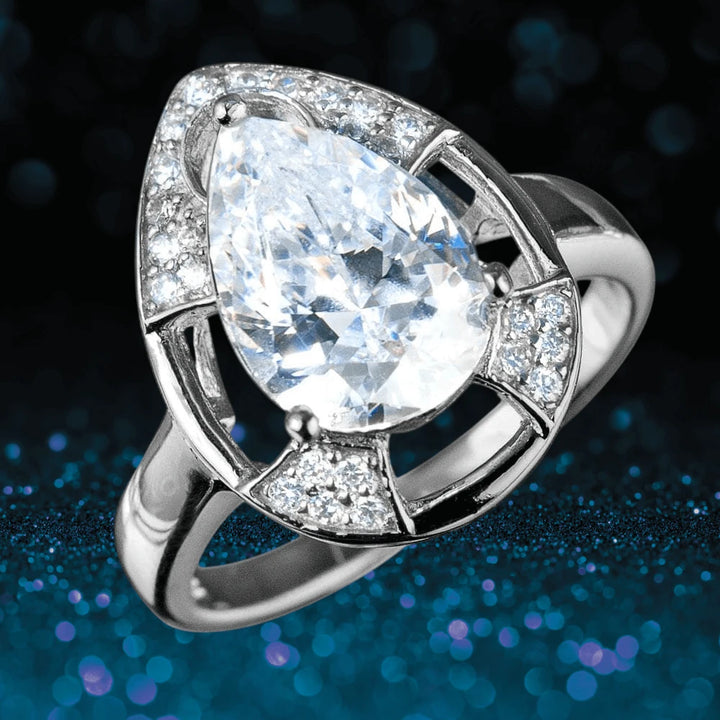 Mandalay Pear Ring featuring a large pear-shaped clear gemstone set in sterling silver with smaller sparkling stones accenting the elegant design for women’s jewelry.
