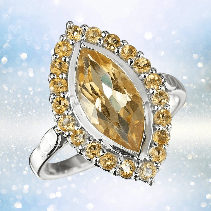 Citrine Solaris Ring featuring a marquise-cut yellow citrine gemstone surrounded by smaller citrine stones set in sterling silver, designed for women’s elegant jewelry collections.