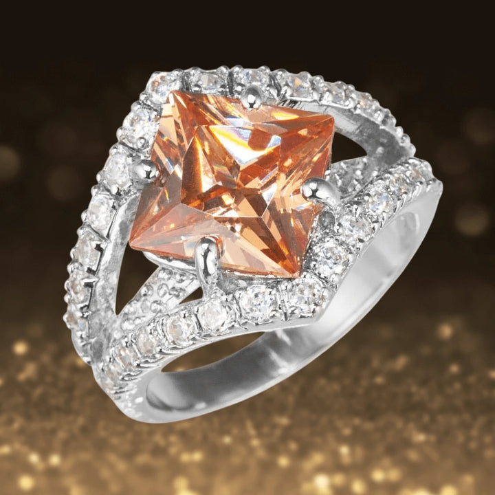 North Star Ring featuring a striking princess-cut orange gemstone set in sterling silver with sparkling pavé accents, designed elegantly for women’s jewelry collections.