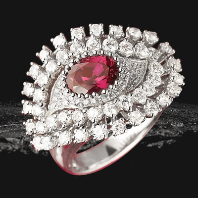 Nazar Rouge Ring featuring a sterling silver band with a central deep red gemstone surrounded by sparkling clear stones, designed for women’s fine jewelry collections.