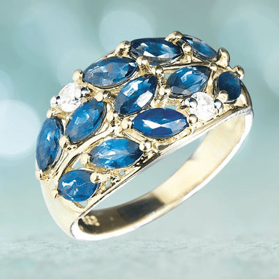 Elegant Marquise Sapphire Ring crafted in sterling silver with gold plating, featuring multiple deep blue marquise-cut sapphire stones set for a refined feminine look.