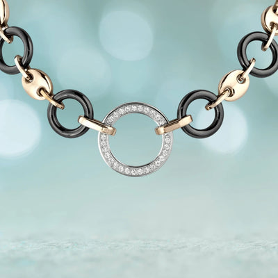 Close-up of the Java Ceramic Halo Necklace featuring a rose gold and stainless steel chain with black ceramic links and a circular pendant encrusted with crystals, designed for women’s jewelry.