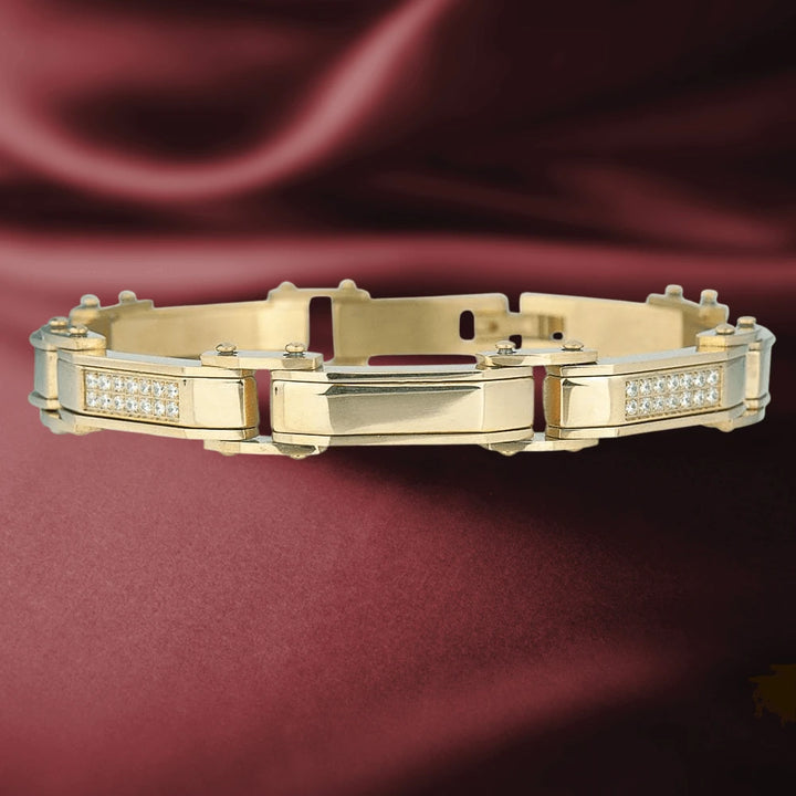 Men's Definition Bracelet in gold-plated stainless steel with a sleek design and embedded clear stones, displayed on a rich burgundy fabric background, showcasing elegant men's jewelry.