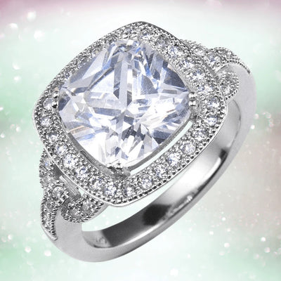 Heirloom Ring featuring a sparkling cushion-cut center stone surrounded by a halo of smaller stones on sterling silver with rhodium plating, designed for women.