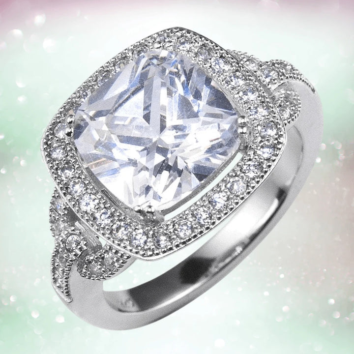 Heirloom Ring featuring a sparkling cushion-cut center stone surrounded by a halo of smaller stones on sterling silver with rhodium plating, designed for women.