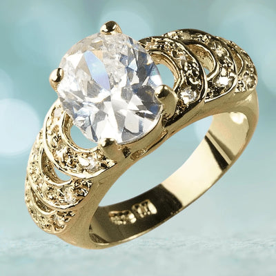 Palm Bay Ring featuring a large clear gemstone set in a sterling silver band plated with gold, designed for female jewelry enthusiasts.