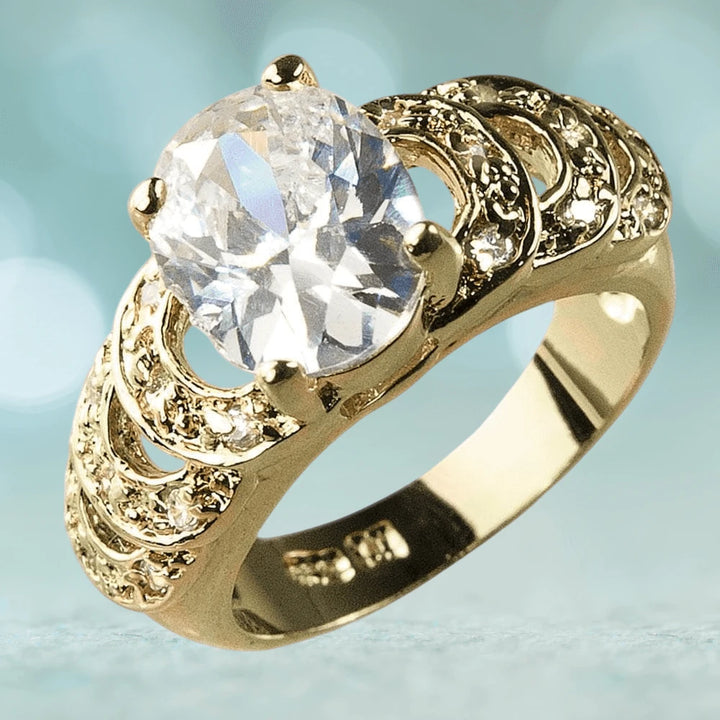 Palm Bay Ring featuring a large clear gemstone set in a sterling silver band plated with gold, designed for female jewelry enthusiasts.