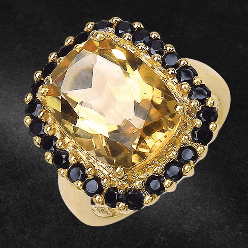 Sunflower Ring featuring a large gold-plated sterling silver band with a central faceted yellow gemstone surrounded by small black stones, designed for women’s jewelry.
