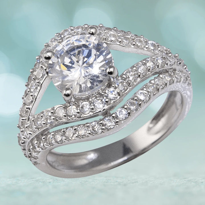 Malocchio Rhodium Ring featuring a sterling silver band with rhodium plating, adorned with a large central clear gemstone and smaller accent stones, designed for women.