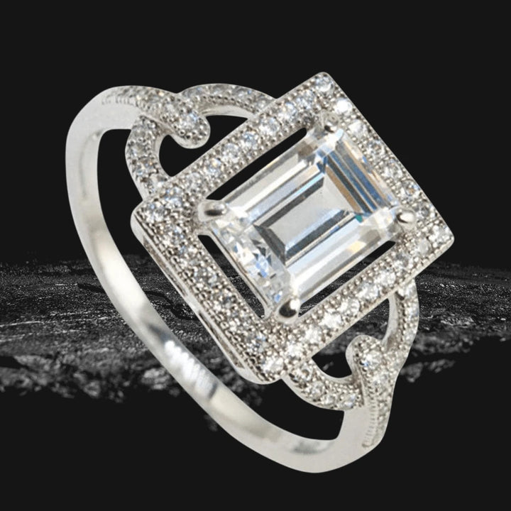 Astoria White Ring featuring a sterling silver band with rhodium plating, showcasing a square-cut center stone surrounded by intricate pavé detailing, designed for women’s jewelry.