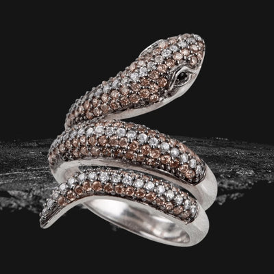 Serpent Ring crafted from sterling silver with rhodium plating, featuring an intricate serpent design adorned with sparkling brown and white stones for a striking feminine jewelry statement.