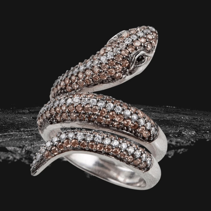 Serpent Ring crafted from sterling silver with rhodium plating, featuring an intricate serpent design adorned with sparkling brown and white stones for a striking feminine jewelry statement.