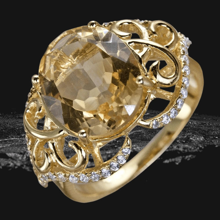 Citrine Solero Ring featuring a large faceted citrine gemstone set in a gold-plated sterling silver band with intricate scrollwork and sparkling clear accents, designed for women.