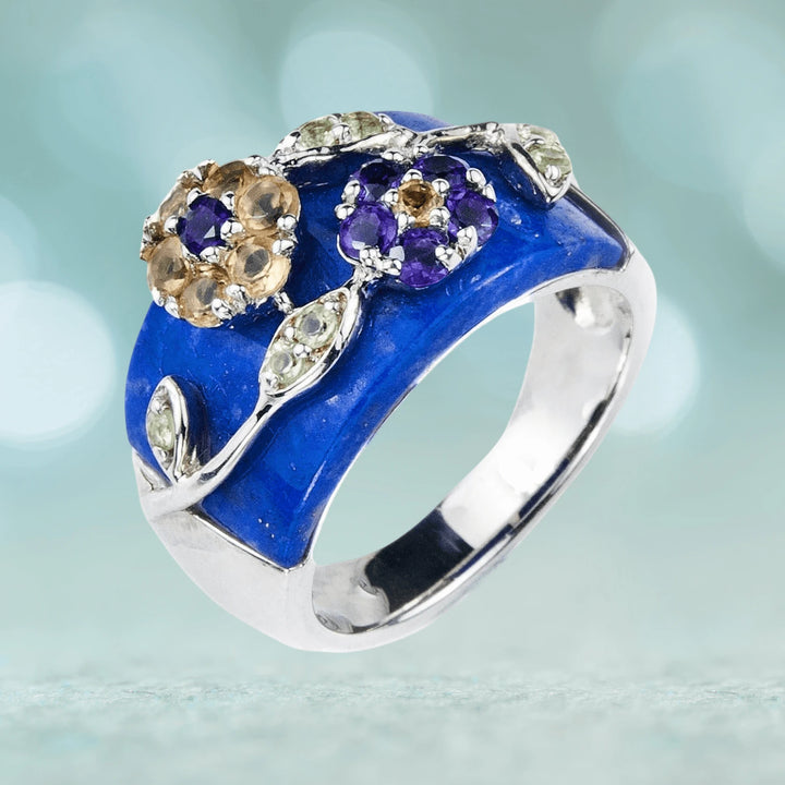 Babylon Ring featuring sterling silver with rhodium plating, showcasing a vibrant blue enamel band accented by intricate floral designs with purple and light brown gemstones, designed for female jewelry.