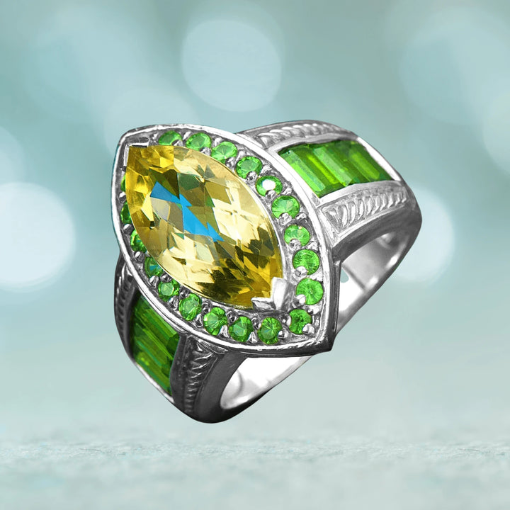 Verdissimo Ring featuring a sterling silver band with rhodium plating, adorned with a large yellow gemstone surrounded by small green stones and rectangular green accents.