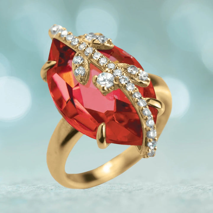Fire Vine Ring featuring a large red gemstone set in sterling silver with gold plating, accented by sparkling clear crystals in an elegant vine design for women’s jewelry.