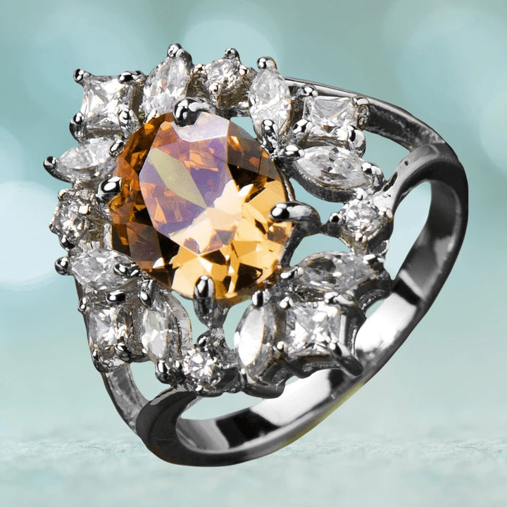 Sterling silver Champagne Spray Ring with rhodium plating, featuring a central amber gemstone surrounded by multiple clear sparkling stones, designed for women’s jewelry.