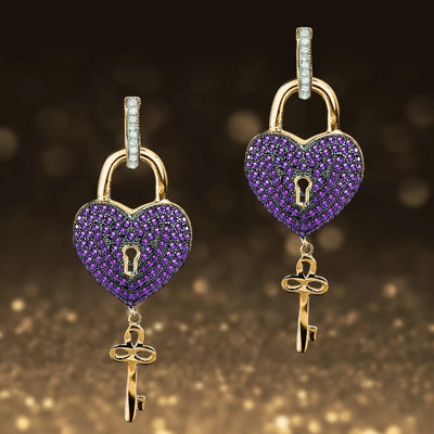 Paris Heart Earrings featuring sterling silver with gold plating, shaped as heart lockets adorned with purple stones and a dangling gold key, designed for women’s jewelry.