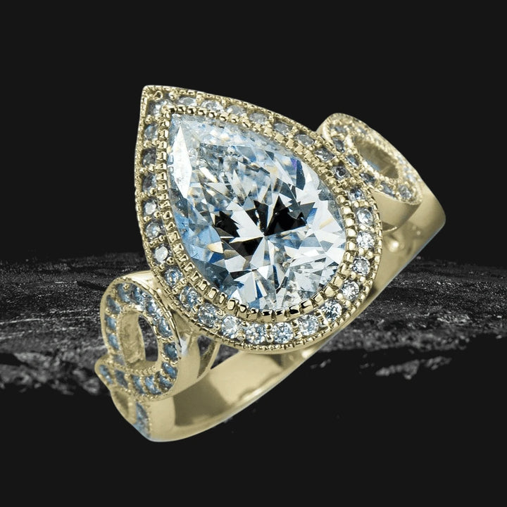 Marie Anna Teardrop Gold Ring featuring a large teardrop-shaped crystal center stone surrounded by smaller crystals on a sterling silver band with gold plating designed for women.