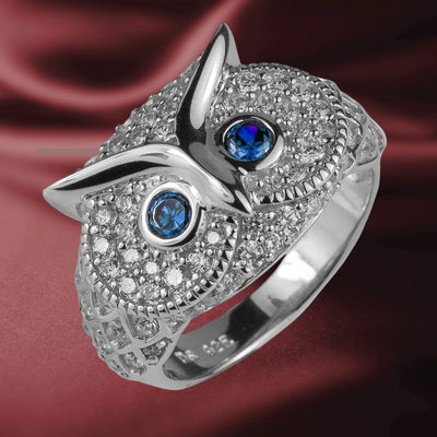 Owl Rhodium Ring crafted in sterling silver with rhodium plating, featuring intricate detailing and blue gemstone eyes, designed for women’s jewelry collections.