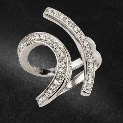 Lola Ring Rhodium featuring a modern spiral design crafted from sterling silver with rhodium plating, adorned with sparkling clear stones for elegant jewelry appeal.