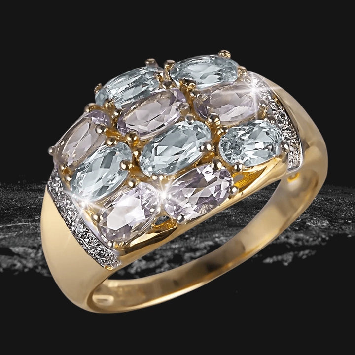 Wysteria Sky Ring featuring a sterling silver band plated in gold with multiple oval-cut light blue and lavender gemstones, designed for women’s elegant jewelry collection.
