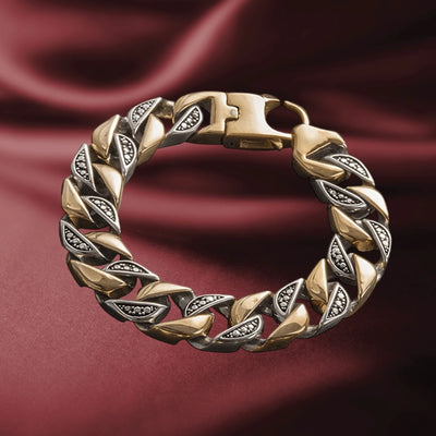 Great Portland Steel Bracelet for men, featuring a two-tone stainless steel design with polished and textured links, displayed on a rich burgundy fabric background.