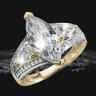 Millionaire Marquise Two Tone Ring featuring a sterling silver band with two-tone plating and a large marquise-cut clear stone flanked by smaller triangular stones and diamond accents.