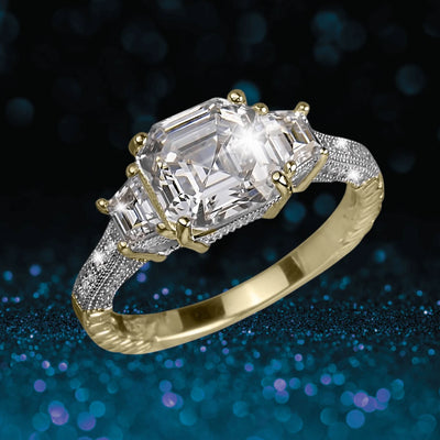 Valdera Ring features a two-tone sterling silver band with a large central emerald-cut gemstone flanked by smaller emerald-cut stones, designed for women’s jewelry.
