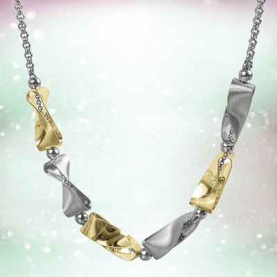 Clementine Twist Necklace featuring two-tone sterling silver with a modern twist design, combining polished gold and silver tones for elegant women’s jewelry.