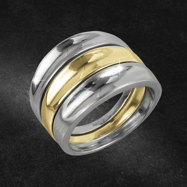 Clementine Twist Ring featuring a two-tone sterling silver design with a polished gold center band, elegant and stylish jewelry for female wearers.