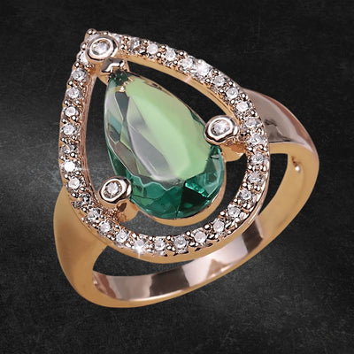 Peardrop Ring featuring a sterling silver band with a large green gemstone centerpiece surrounded by smaller clear stones, designed for female jewelry lovers.