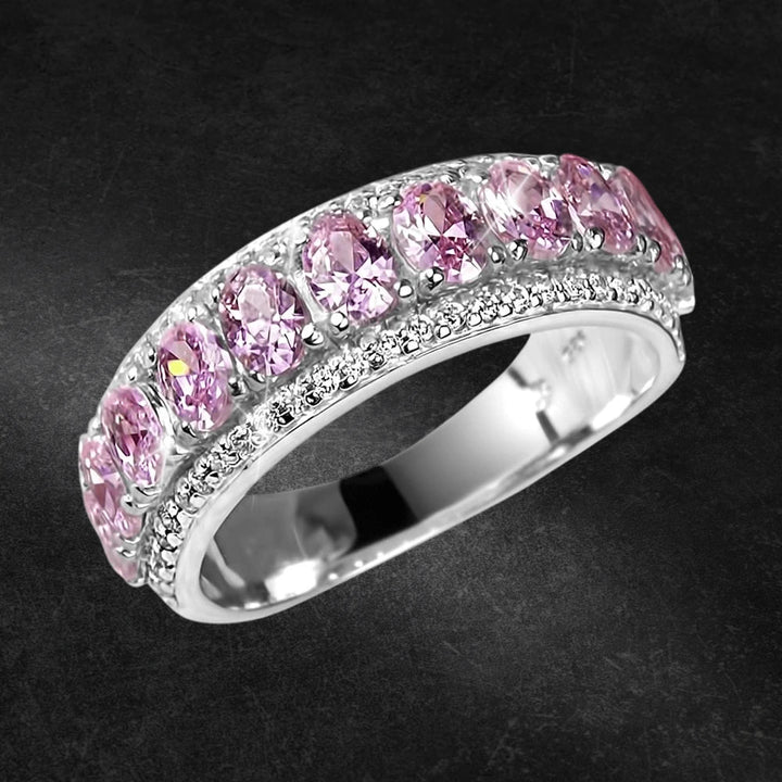 Blush Eternity Ring featuring sterling silver with rhodium plating, adorned with a row of sparkling pink gemstones designed for women’s jewelry collections.