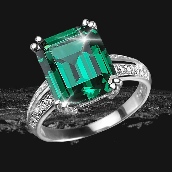 Sterling silver Verdana Ring for female featuring a large emerald-cut green gemstone with rhodium plating and small accent diamonds on the band.