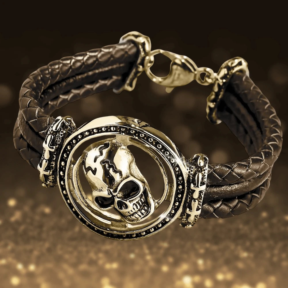 Skull Arena Gold Bracelet featuring a bold gold-plated stainless steel skull centerpiece on a woven black leather band, designed for a striking male jewelry statement.