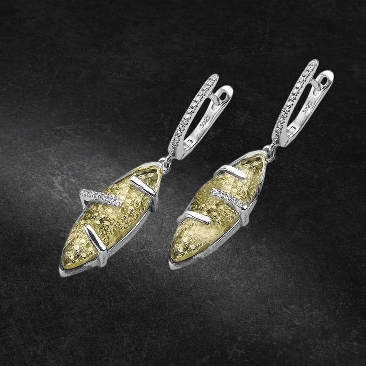 Captured Earrings featuring sterling silver with rhodium plating, showcasing a unique textured design accented by sparkling details, crafted for women’s jewelry collections.