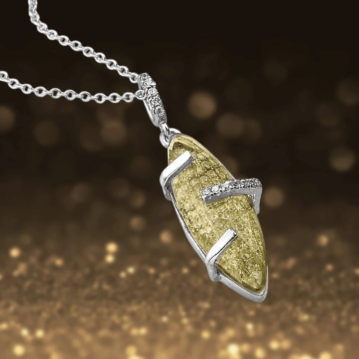 Captured Pendant showcasing a sterling silver chain with rhodium-plated accents holding a textured yellow gemstone, designed for female jewelry lovers.