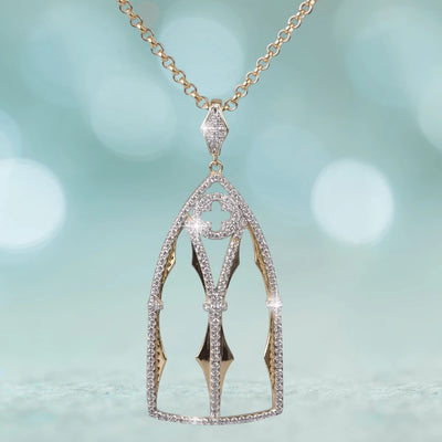 Abbey Pendant featuring a sterling silver and gold design with intricate details and sparkling accents, suspended from a gold chain, crafted for women’s jewelry collections.