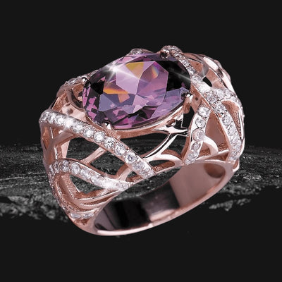 Entwined Rose Gold Ring featuring an intricate sterling silver design plated in rose gold, adorned with sparkling clear stones and a large faceted purple gemstone centerpiece.