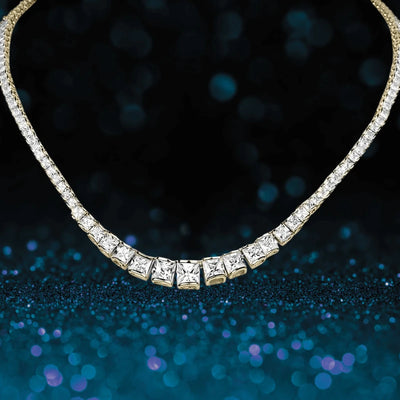 Elegant Starlet Gold Necklace featuring a row of sparkling square-cut stones designed for women, set against a shimmering dark blue background.