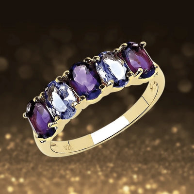 Dafina Tanzanite Ring featuring an elegant row of alternating purple and blue tanzanite gemstones set in gold-plated sterling silver, designed for women’s jewelry collections.