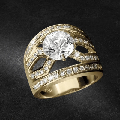 Malaga Golden Ring featuring a sterling silver base plated in gold, adorned with a large central clear gemstone and multiple smaller sparkling stones, designed for women’s jewelry.