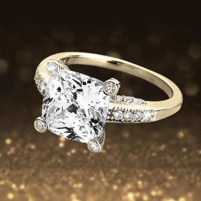 Fiji Golden Princess Ring featuring a sterling silver band with gold plating, adorned with a large princess-cut clear stone and smaller sparkling accent stones.