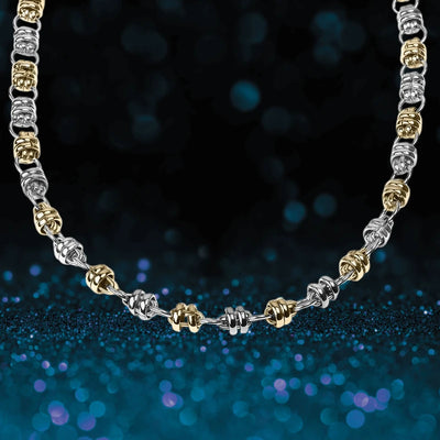 Quintus Steel Necklace featuring alternating silver and gold-tone links designed for male jewelry, creating a bold and stylish statement piece.